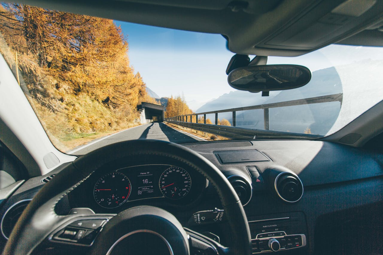 Windshield view of a car on a scenic road